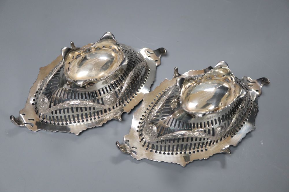 A pair Victorian pierced and cast silver oval bon bon dishes, London 1895, maker Thomas Bradbury, 19.2cm, 11oz.